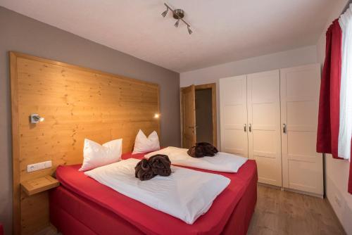 a bedroom with a bed with two bags on it at Haus Alpenblick Lofer in Lofer