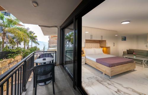 a bedroom with a bed and a balcony at Mirage Bay Deluxe in Sarandë