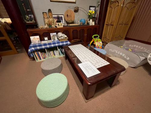 a room with a desk with a keyboard and a stool at Uchihan in Nozawa Onsen