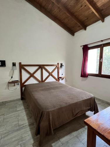 a bedroom with a large bed in a room at Cabañas El Campo in Sierra de la Ventana