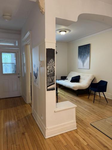 a living room with a bed and a table at Verdun Beach, House in Montreal