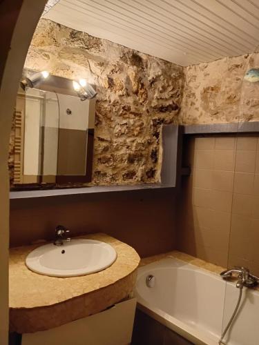 a bathroom with a sink and a bath tub at LE PANORAMIC- Sainte Agnès in Sainte-Agnès