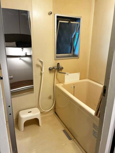 a bathroom with a bath tub and a toilet at Recasa in Imabari