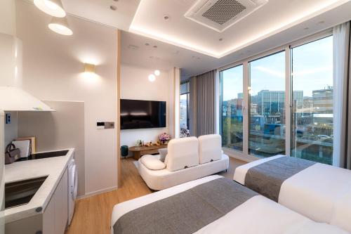 a hotel room with two beds and a television at STAY On-A in Seoul