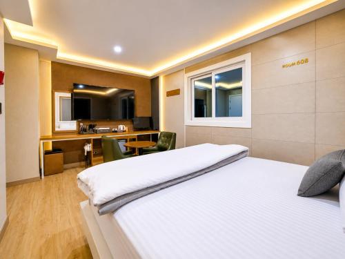 a hotel room with a bed and a desk at 대구 동천 스위트 호텔 in Daegu