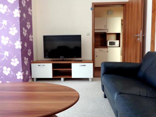 a living room with a couch and a flat screen tv at Penzión Reduta in Oravský Podzámok