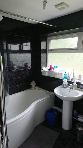 a bathroom with a bathtub and a sink and a bath tub at Shephall Zoo in Shephall
