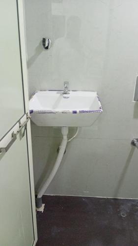 a bathroom with a white sink in a room at Munot residency in Manmād