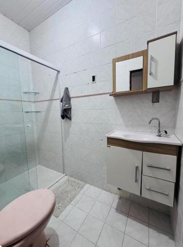 a bathroom with a shower and a toilet and a sink at Suíte com ampla área externa - Pink in São Luís
