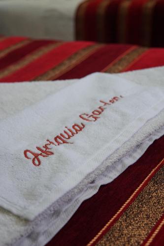 a white napkin with the words merry christmas on it at Riad Afriquia Garden in Marrakesh
