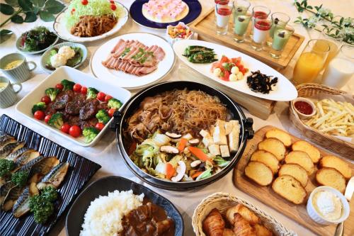 a table with many plates of food on it at Hotel Gracery Asakusa in Tokyo