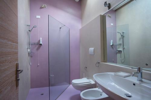 a bathroom with a sink and a toilet and a shower at Dormire alla Ruota in Negrar