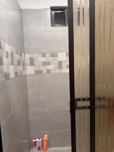 a shower with a glass door in a bathroom at Casa Malu in Morote