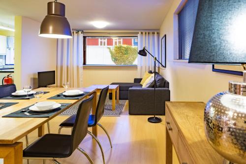 a dining room and living room with a table and chairs at Guesthouse Sunna in Reykjavík