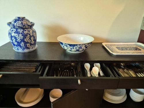 a table with a vase and bowls on top of it at Meadowridge Haven in Maple Ridge