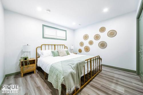 a white bedroom with a bed and a window at Spacious Bright Suite - Sleeps 4 - King Bed - NFLX in Edmonton