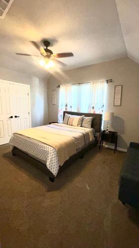 a bedroom with a bed and a ceiling fan at My house your house in Fort Smith