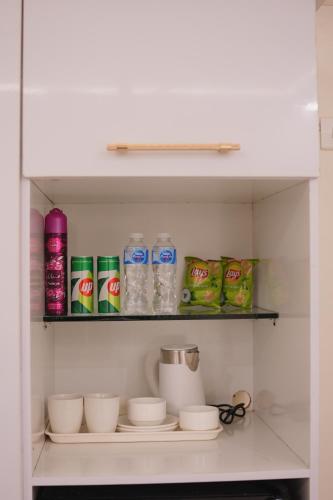 a shelf in a refrigerator filled with food and drinks at Pc Inn Executive Class Hotel in Sukkur