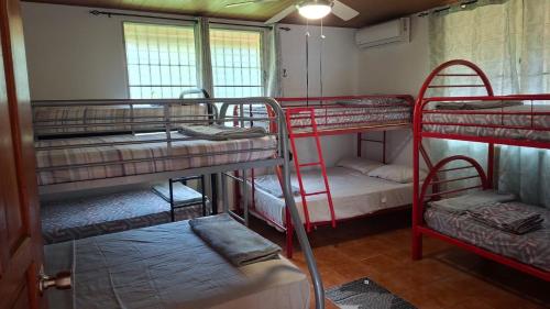 a room with three bunk beds in a room at Casa naranjita in Chame