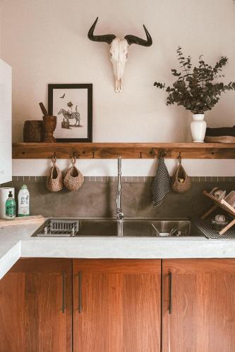 a kitchen with a sink and a cow skull on the wall at Lala Lodge in Hoedspruit