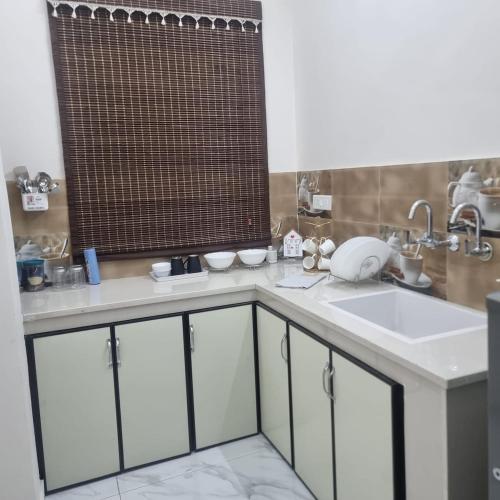 a kitchen with a sink and a mirror at Forest breeze villa in Jalandhar