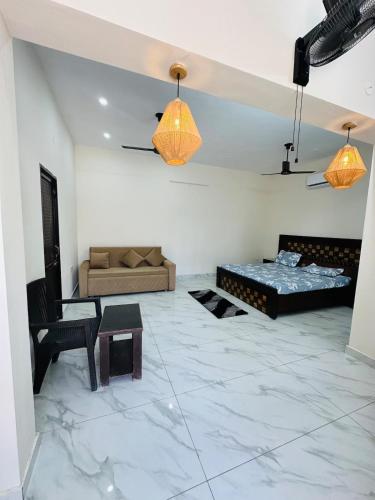 a living room with two beds and a couch at Forest breeze villa in Jalandhar