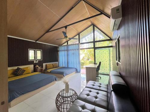 a bedroom with two beds and a couch at Suối Đá F-Glamping 2026 in Thiện Giáo