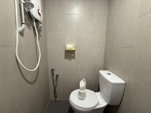 a bathroom with a shower and a toilet in it at Apex Hotel by Setapak Central in Kuala Lumpur