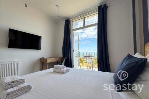 a bedroom with a bed with a tv and a window at Beach Lookout Direct Access to Viking Bay Sleeps 4 in Kent