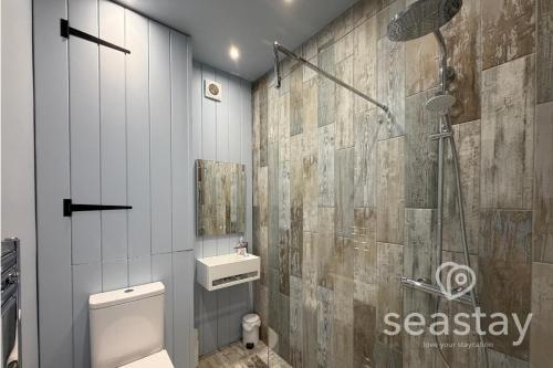 a bathroom with a shower and a toilet and a sink at Beach Lookout Direct Access to Viking Bay Sleeps 4 in Kent