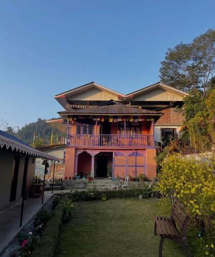 a house with a balcony and a yard at Pakha Dhim Heritage Homestay in Namchi