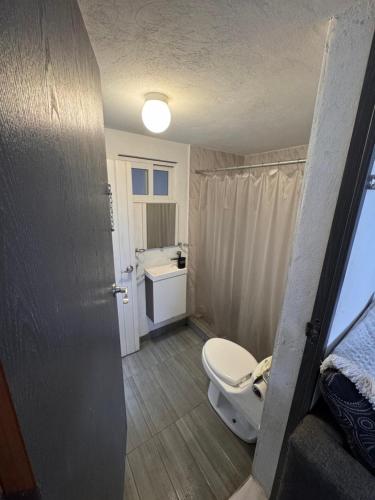 a small bathroom with a toilet and a sink at Mexican House in Mexico City