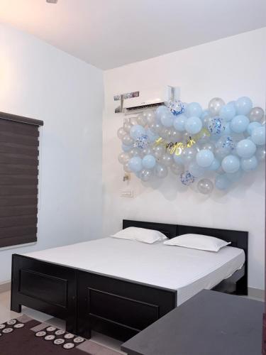 a room with two beds with balloons on the wall at Seawind in Kannur