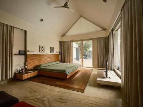 a bedroom with a bed and a large window at RB Villa in Indore