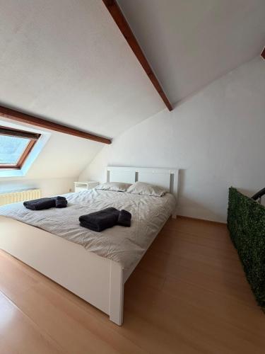 a bedroom with a white bed in a attic at Le Studio Central in Huy