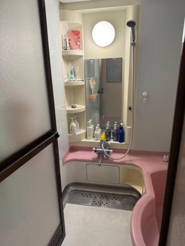 a bathroom with a sink and a shower at 安易旅館3号房间 in Okayama