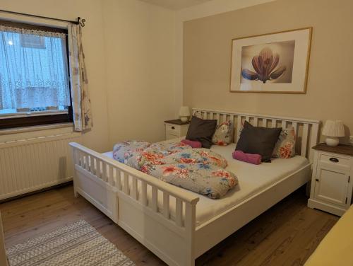 a bedroom with a white crib with pillows at Haus Senn in Seefeld in Tirol