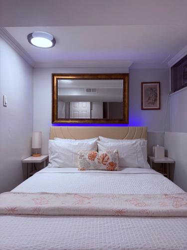 a bedroom with a large bed with a mirror above it at Intercon Ground in Queens