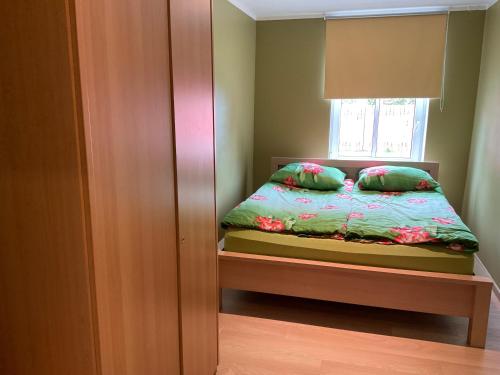 a small bedroom with a bed and a window at Jaani 2-1 Apartment in Pärnu