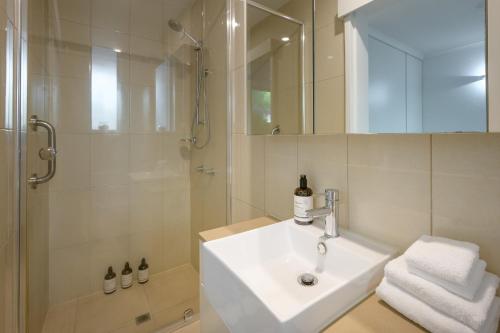 a white bathroom with a sink and a shower at 3WR Sunshine Beach Dream 3BR in Sunshine Beach