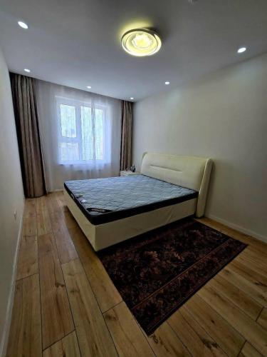 a bedroom with a bed in a room with a rug at Arga bilig complex in Ulaanbaatar