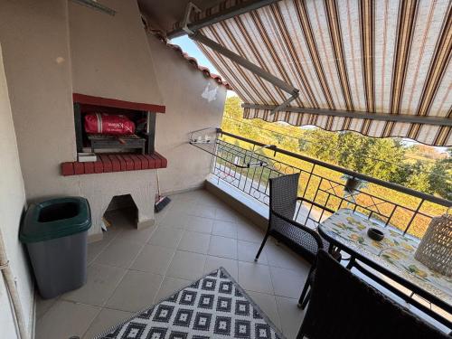 a room with a balcony with a table and a window at Apartment Las 2 in Fanari