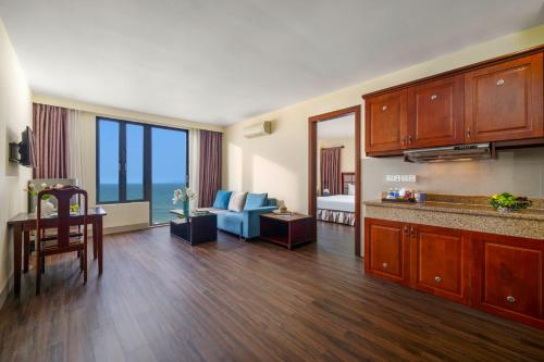 a living room with a kitchen and a living room at Sea Front Apartment & Spa Da Nang in Danang