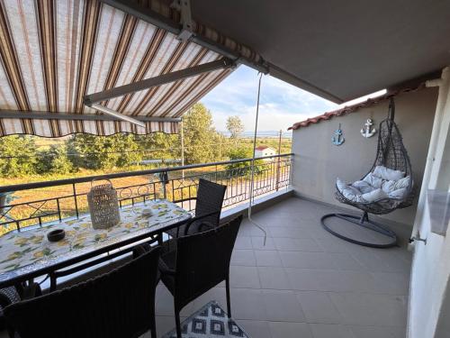a balcony with a hammock and a table and chairs at Apartment Las 2 in Fanari