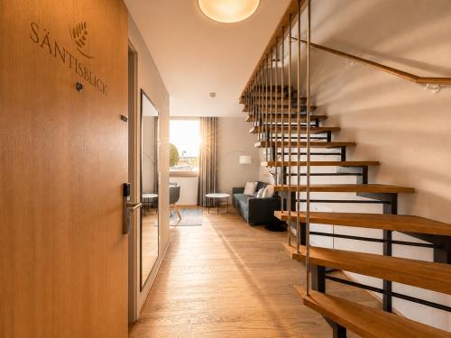 a staircase in a house with a living room at LAKE-SIDE Säntisblick in Romanshorn