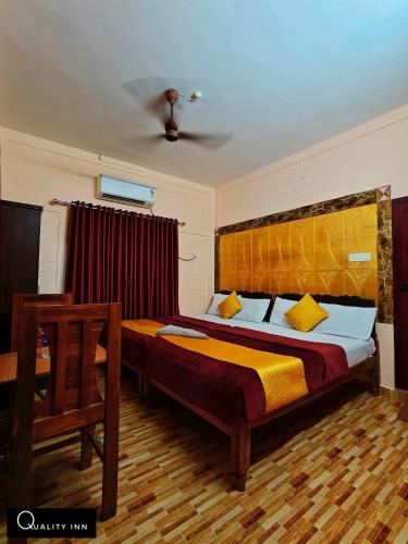 a bedroom with a large bed in a room at Quality Inn Resort in Varkala