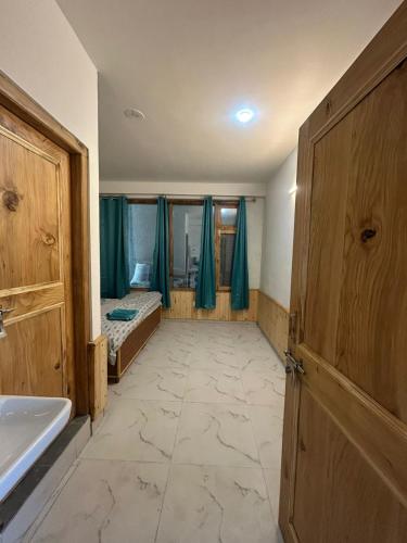an empty bathroom with a sink and a door at Nashala View Homestay in Nagar