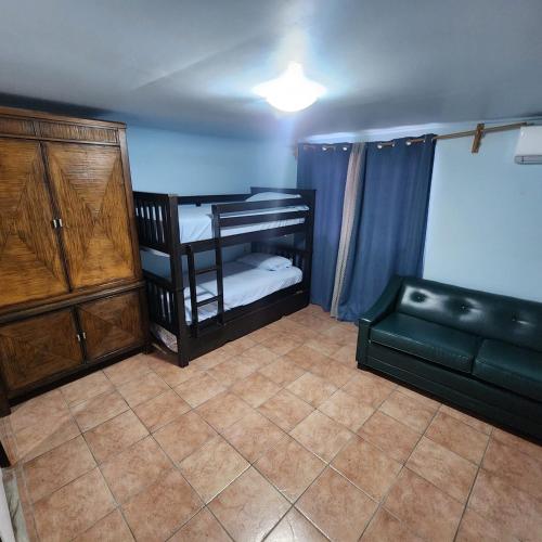 a room with two bunk beds and a couch at Casa Caribe in San Felipe