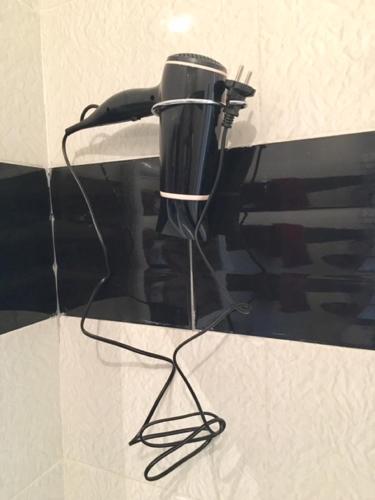 a black blow dryer sitting on top of a counter at Appart Hotel Tanger Paname in Tangier