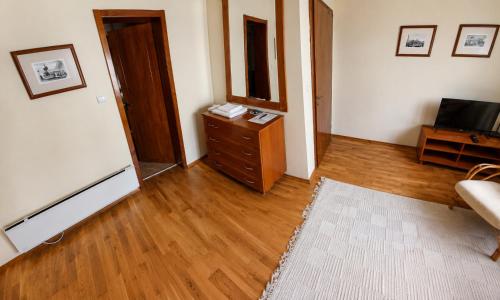 a living room with a dresser and a television at Room 2 in Gotse Delchev